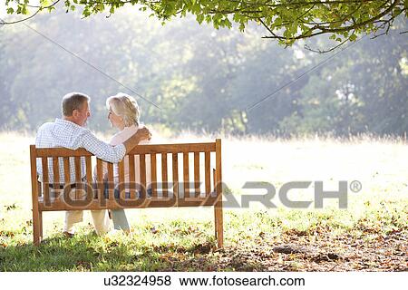 Senior couple sitting outdoors View Large Photo Image Stock Photo - Senior couple sitting outdoors. Fotosearch