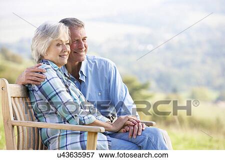 Stock Photo - Senior couple sitting outdoors. Fotosearch