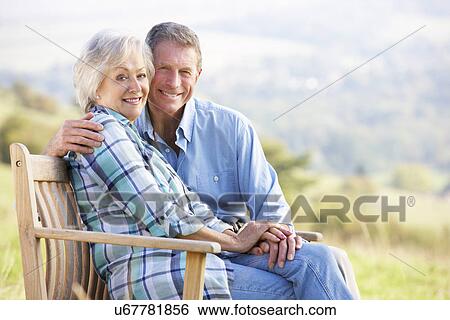 Senior couple sitting outdoors View Large Photo Image Stock Photograph - Senior couple sitting outdoors. Fotosearch