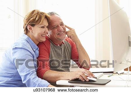Stock Photo - Senior Couple Using Computer At Home. Fotosearch