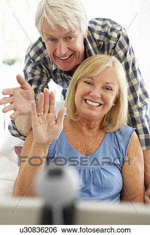 Stock Photograph - Senior couple using skype. Fotosearch