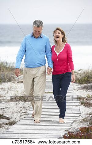 Senior couple walking by the sea View Large Photo Image Picture - Senior couple walking by the sea. Fotosearch
