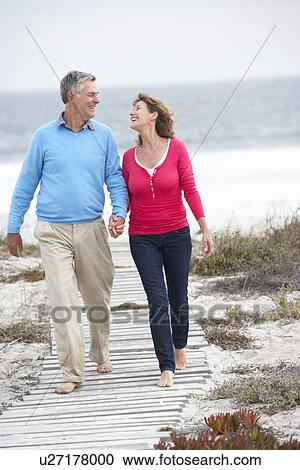 Senior couple walking by the sea View Large Photo Image Stock Image - Senior couple walking by the sea. Fotosearch