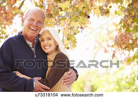 Senior Couple Walking Through Autumn Woodland View Large Photo Image Picture - Senior Couple Walking Through Autumn Woodland. Fotosearch