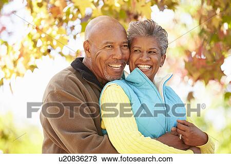 Senior Couple Walking Through Autumn Woodland View Large Photo Image Stock Photo - Senior Couple Walking Through Autumn Woodland. Fotosearch