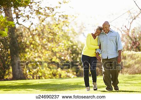 Senior Couple Walking Through Autumn Woodland View Large Photo Image Stock Photo - Senior Couple Walking Through Autumn Woodland. Fotosearch