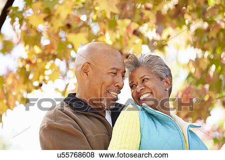 Senior Couple Walking Through Autumn Woodland View Large Photo Image Stock Photo - Senior Couple Walking Through Autumn Woodland. Fotosearch
