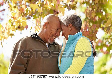Senior Couple Walking Through Autumn Woodland View Large Photo Image Stock Photo - Senior Couple Walking Through Autumn Woodland. Fotosearch
