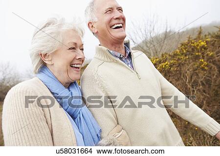 Picture - Senior Couple Walking Through Winter Countryside. Fotosearch