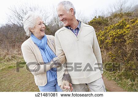 Senior Couple Walking Through Winter Countryside View Large Photo Image Stock Image - Senior Couple Walking Through Winter Countryside. Fotosearch