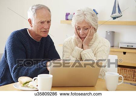 Senior Couple With Financial Problems Looking At Laptop View Large Photo Image Stock Photograph - Senior Couple With Financial Problems Looking At Laptop. Fotosearch
