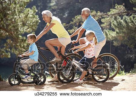 Stock Photography - Senior couple with grandchildren on country bike ride. Fotosearch