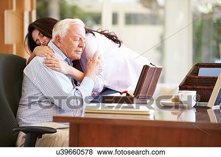 Stock Photo - Senior Father Being Comforted By Adult Daughter. Fotosearch