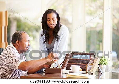 Senior Father Discussing Document With Adult Daughter View Large Photo Image Stock Image - Senior Father Discussing Document With Adult Daughter. Fotosearch