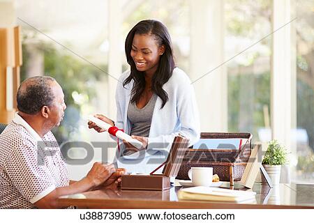 Stock Photography - Senior Father Discussing Document With Adult Daughter. Fotosearch