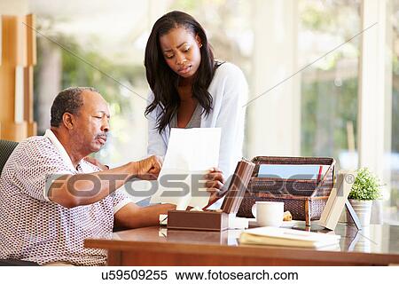 Senior Father Discussing Document With Adult Daughter View Large Photo Image Stock Photography - Senior Father Discussing Document With Adult Daughter. Fotosearch