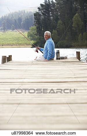 Senior man fishing on jetty View Large Photo Image Picture - Senior man fishing on jetty. Fotosearch