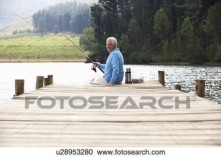Senior man fishing on jetty View Large Photo Image Stock Image - Senior man fishing on jetty. Fotosearch