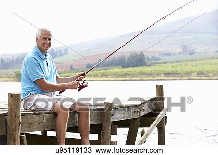 Senior man fishing on jetty View Large Photo Image Stock Image - Senior man fishing on jetty. Fotosearch