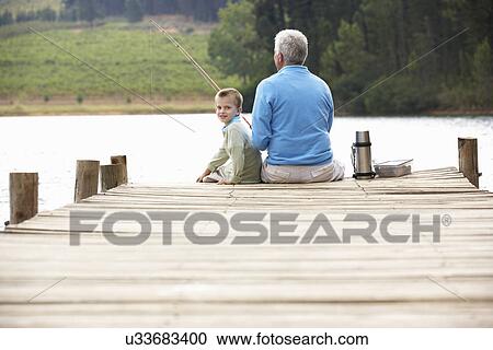 Senior man fishing with grandson View Large Photo Image Stock Image - Senior man fishing with grandson. Fotosearch