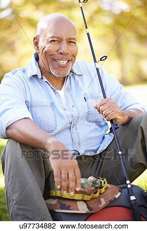 Senior Man On Camping Holiday With Fishing Rod View Large Photo Image Stock Image - Senior Man On Camping Holiday With Fishing Rod. Fotosearch