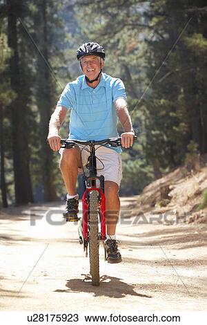 Stock Image - Senior man on country bike ride. Fotosearch
