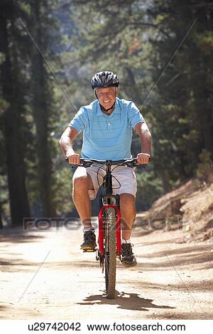 Senior man on country bike ride View Large Photo Image Stock Image - Senior man on country bike ride. Fotosearch