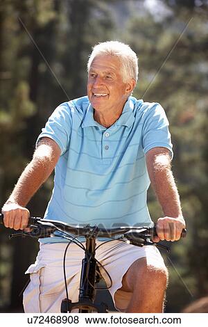 Stock Photo - Senior man on country bike ride. Fotosearch