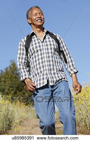 Senior man on country hike View Large Photo Image Stock Image - Senior man on country hike. Fotosearch