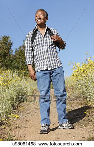 Stock Photo - Senior man on country hike. Fotosearch