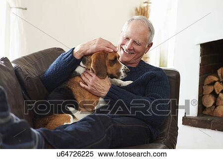 Senior Man Relaxing At Home With Pet Dog View Large Photo Image Stock Photography - Senior Man Relaxing At Home With Pet Dog. Fotosearch