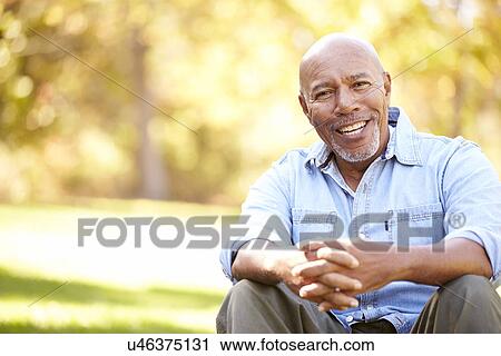 Senior Man Relaxing In Autumn Landscape View Large Photo Image Stock Image - Senior Man Relaxing In Autumn Landscape. Fotosearch