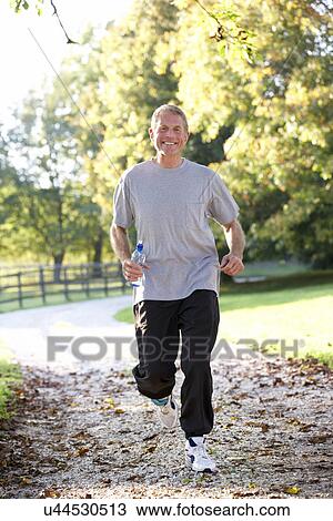 Stock Image - Senior man running in park. Fotosearch