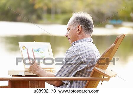 Senior Man Sitting At Outdoor Table Painting Landscape View Large Photo Image Stock Image - Senior Man Sitting At Outdoor Table Painting Landscape. Fotosearch