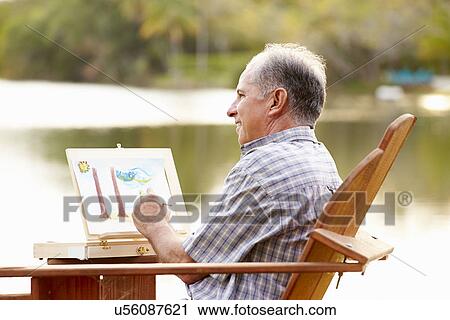 Senior Man Sitting At Outdoor Table Painting Landscape View Large Photo Image Stock Image - Senior Man Sitting At Outdoor Table Painting Landscape. Fotosearch
