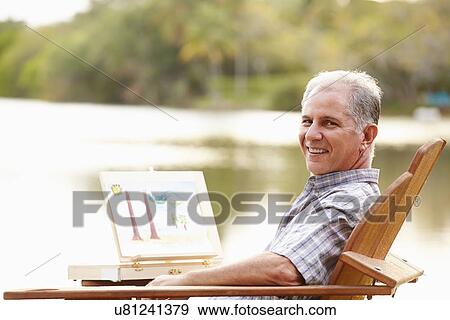 Senior Man Sitting At Outdoor Table Painting Landscape View Large Photo Image Stock Photo - Senior Man Sitting At Outdoor Table Painting Landscape. Fotosearch