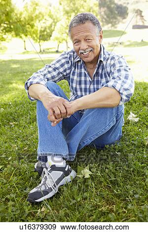 Senior man sitting in park View Large Photo Image Stock Photo - Senior man sitting in park. Fotosearch