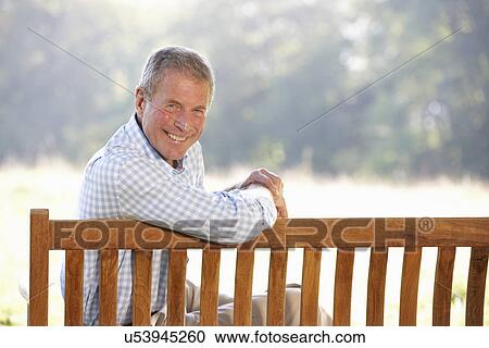 Senior man sitting outdoors View Large Photo Image Stock Image - Senior man sitting outdoors. Fotosearch
