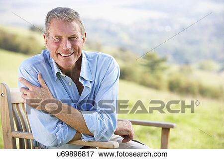 Senior man sitting outdoors View Large Photo Image Stock Photo - Senior man sitting outdoors. Fotosearch