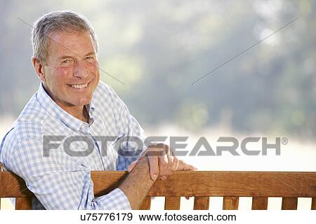 Stock Photo - Senior man sitting outdoors. Fotosearch