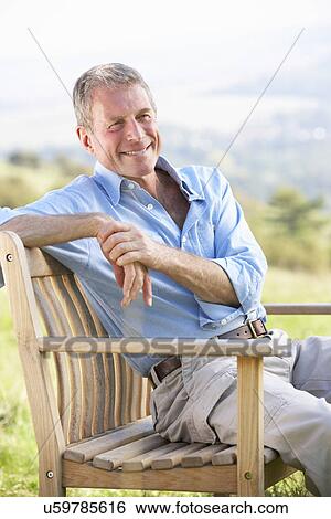 Stock Photograph - Senior man sitting outdoors. Fotosearch
