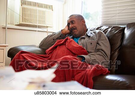 Senior Man Trying To Keep Warm Under Blanket At Home View Large Photo Image Picture - Senior Man Trying To Keep Warm Under Blanket At Home. Fotosearch