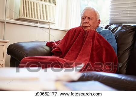 Senior Man Trying To Keep Warm Under Blanket At Home View Large Photo Image Stock Photo - Senior Man Trying To Keep Warm Under Blanket At Home. Fotosearch