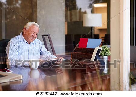 Senior Man Using Digital Tablet Through Window View Large Photo Image Stock Image - Senior Man Using Digital Tablet Through Window. Fotosearch