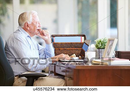 Senior Man Using Laptop On Desk At Home View Large Photo Image Picture - Senior Man Using Laptop On Desk At Home. Fotosearch