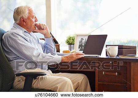 Senior Man Using Laptop On Desk At Home View Large Photo Image Stock Image - Senior Man Using Laptop On Desk At Home. Fotosearch