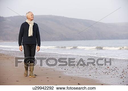 Senior Man Walking Along Winter Beach View Large Photo Image Stock Image - Senior Man Walking Along Winter Beach. Fotosearch