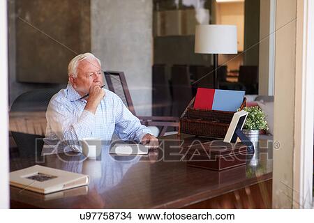 Senior Man Writing Memoirs In Book Sitting At Desk View Large Photo Image Picture - Senior Man Writing Memoirs In Book Sitting At Desk. Fotosearch