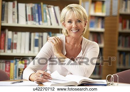 Senior student working in library View Large Photo Image Stock Image - Senior student working in library. Fotosearch