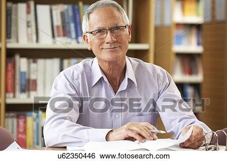 Senior student working in library View Large Photo Image Stock Photograph - Senior student working in library. Fotosearch